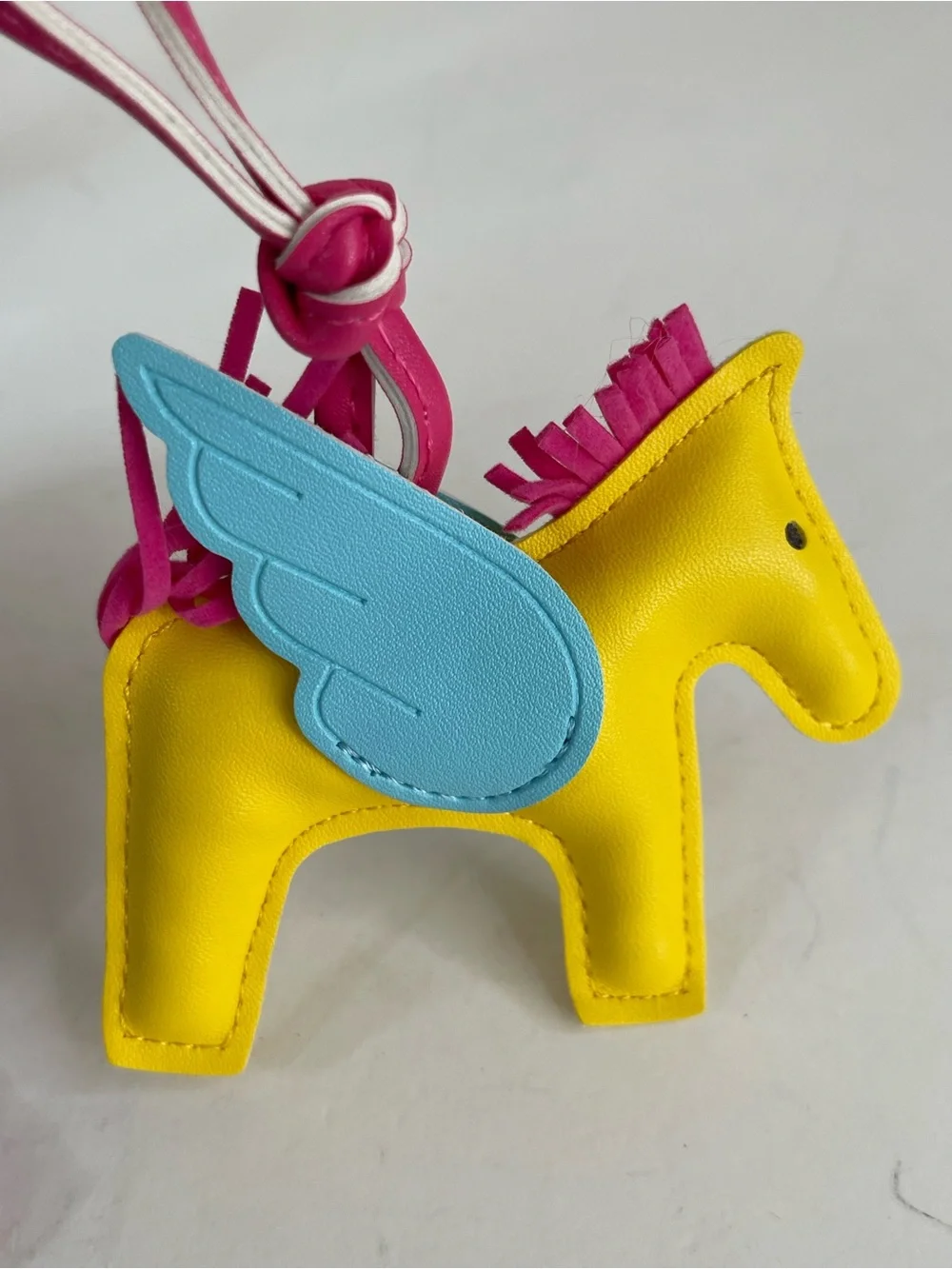 Bright Yellow Pony Bag Charm with Blue Wings and Purple Tassel